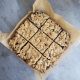 An overhead shot of a baking dish with nine square fresh baked breakfast bars.