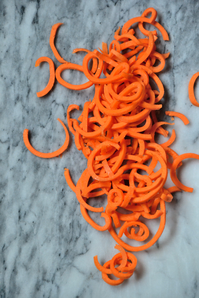 Spiralized curly carrots naturally sweet and ready to be tossed into the pan for sauteing for the Grain-Free Easy Fajitas.